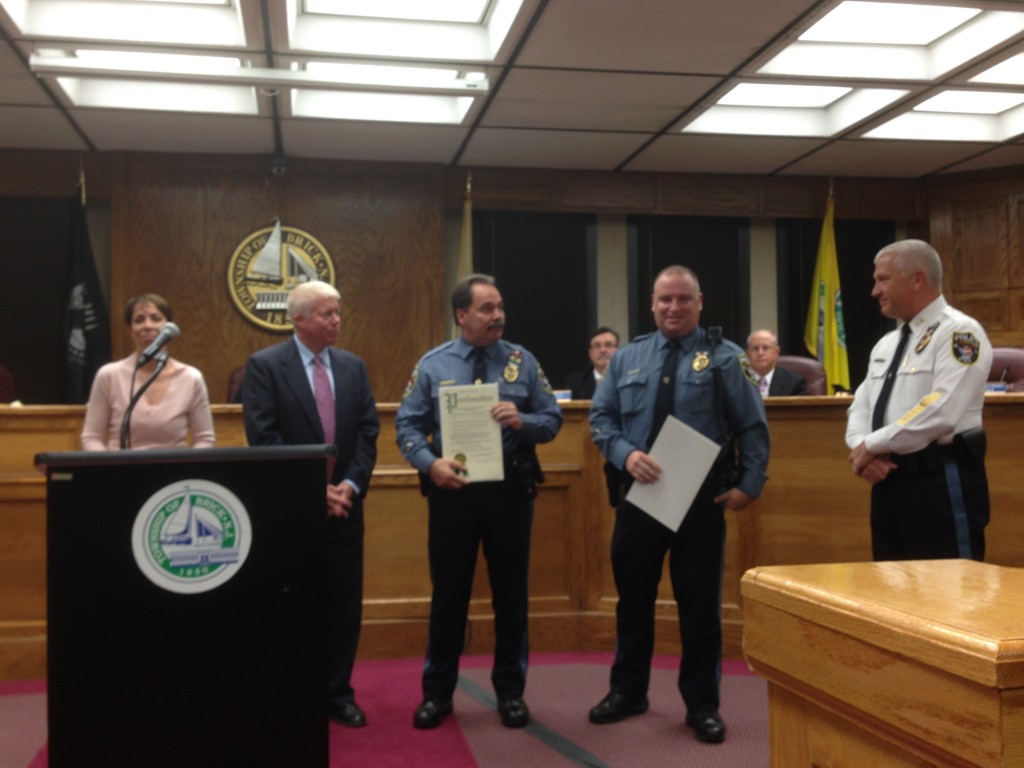 Brick's traffic safety officers receive a copy of a council resolution thanking them for their service. (Photo: Daniel Nee)