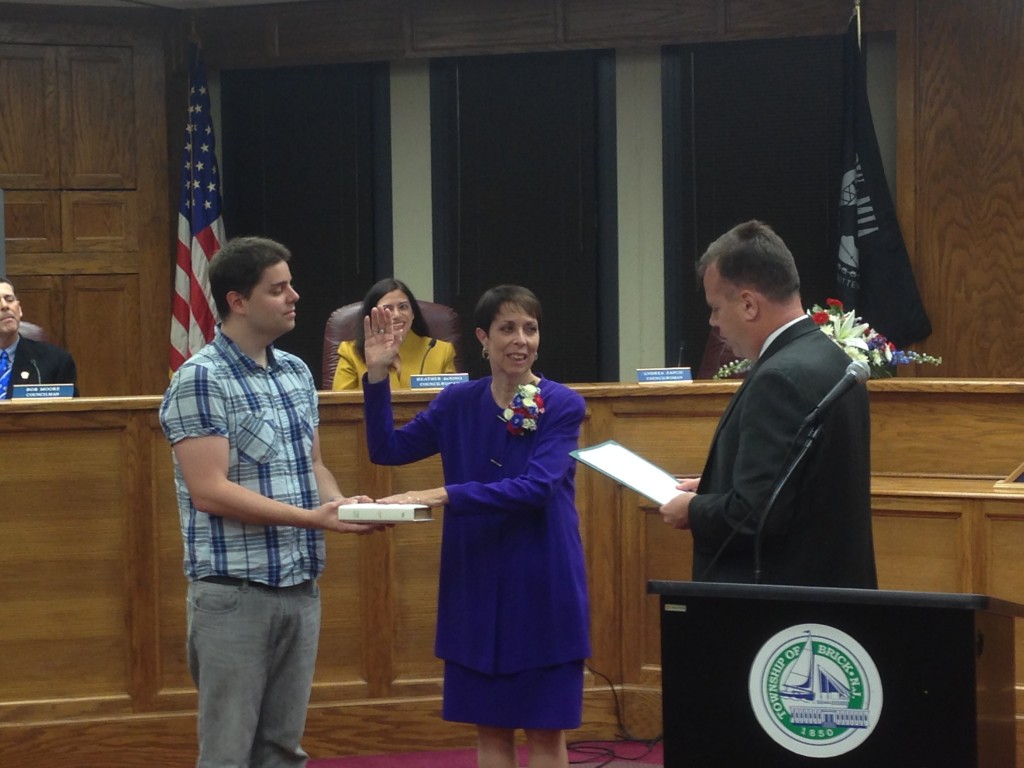 Brick Councilwoman Andrea Zapcic is sworn into office Nov. 10, 2014, by township attorney Kevin Starkey, as her son holds the Bible. (Photo: Daniel Nee)