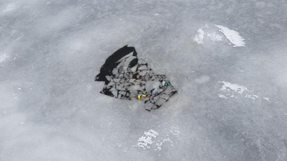 A hole in The ice of the Toms River where a truck was found Sunday morning. (USCG Photo)