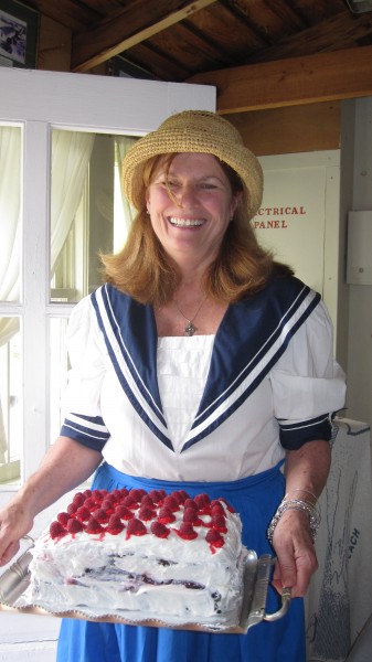 Recording secretary Elaine McGuire of Brick with cake for the tea.