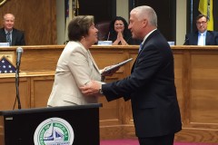 Police Chief Nils R. Bergquist accepts a plaque on behalf of the police department from Carol Wolfe. (Photo: Daniel Nee)