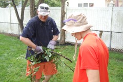Volunteers with Northern Ocean Habitat for Humanity help spruce up a yard in Brick. (Photo: Daniel Nee)