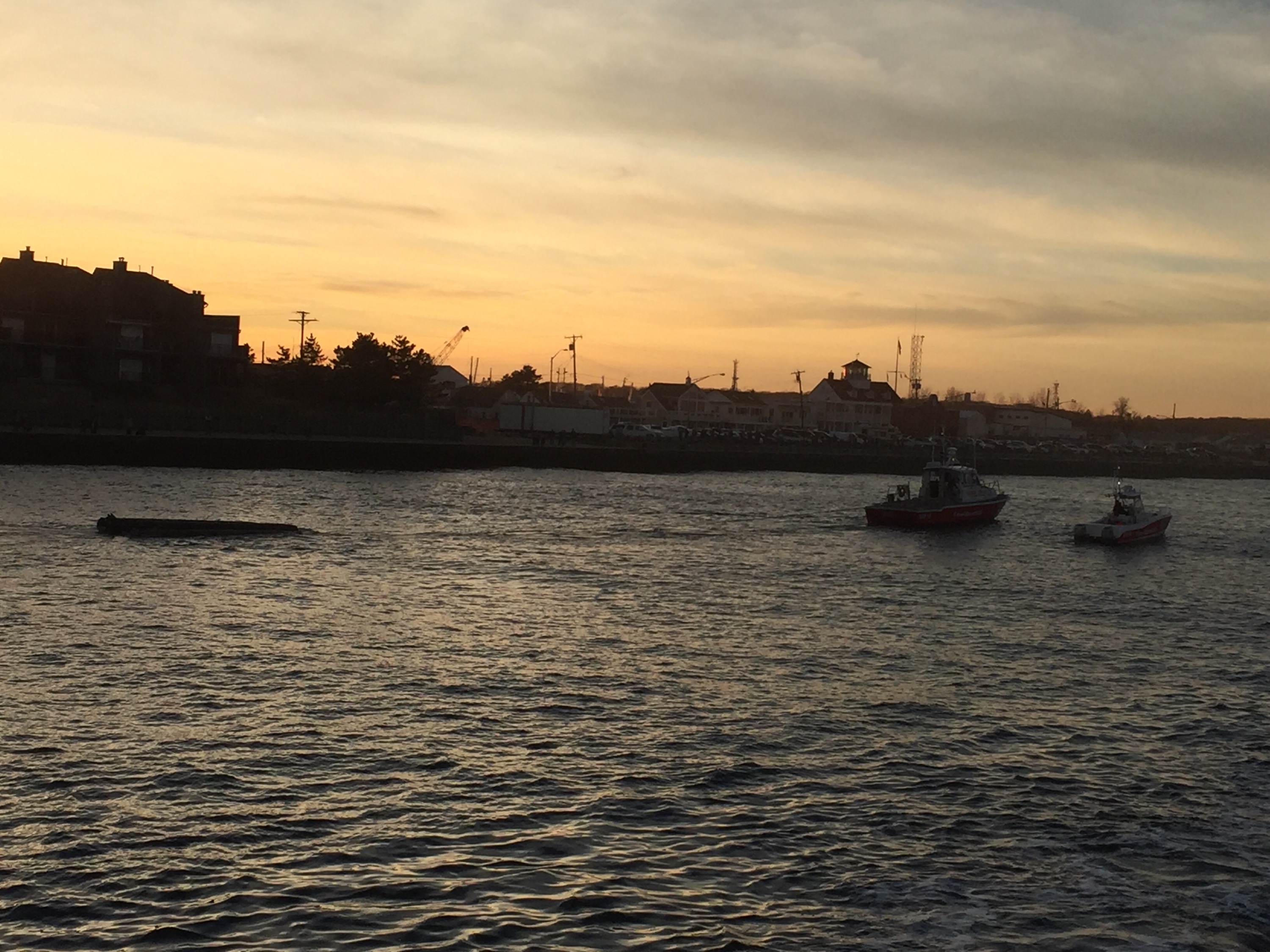 A pontoon boat that capsized off Manasquan Inlet is towed in. (Photo: Daniel Nee)