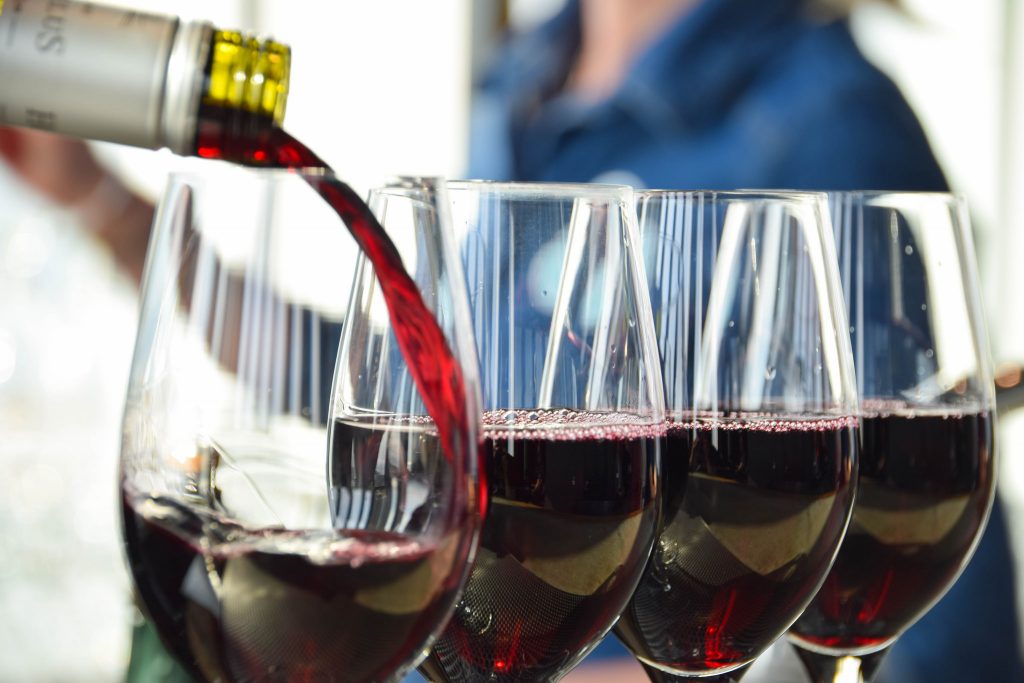 Wine being poured at a bar. (Credit: Maria Eklind/ Flickr)