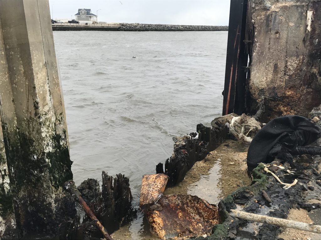 A hole in the bulkhead on the Point Pleasant side of Manasquan Inlet. (Photo: Daniel Nee)