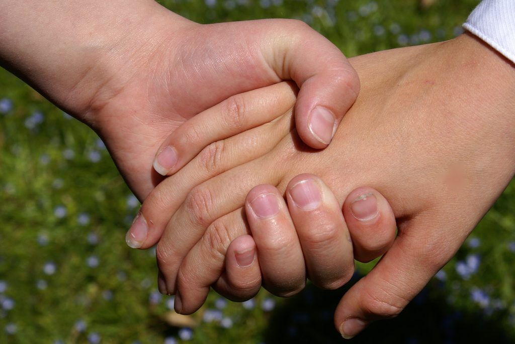 Holding hands. (Credit: fromcolettewithlove/ Flickr)