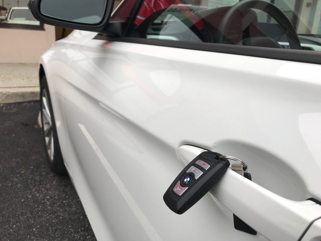 An electronic key fob next to a car door handle. (Photo: Daniel Nee)