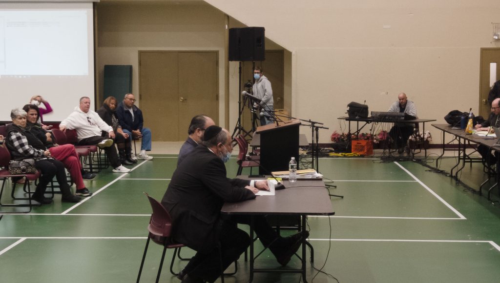David Pollack (foreground) answers questions posed by attorney Adam Pfeffer. (Photo: Daniel Nee)