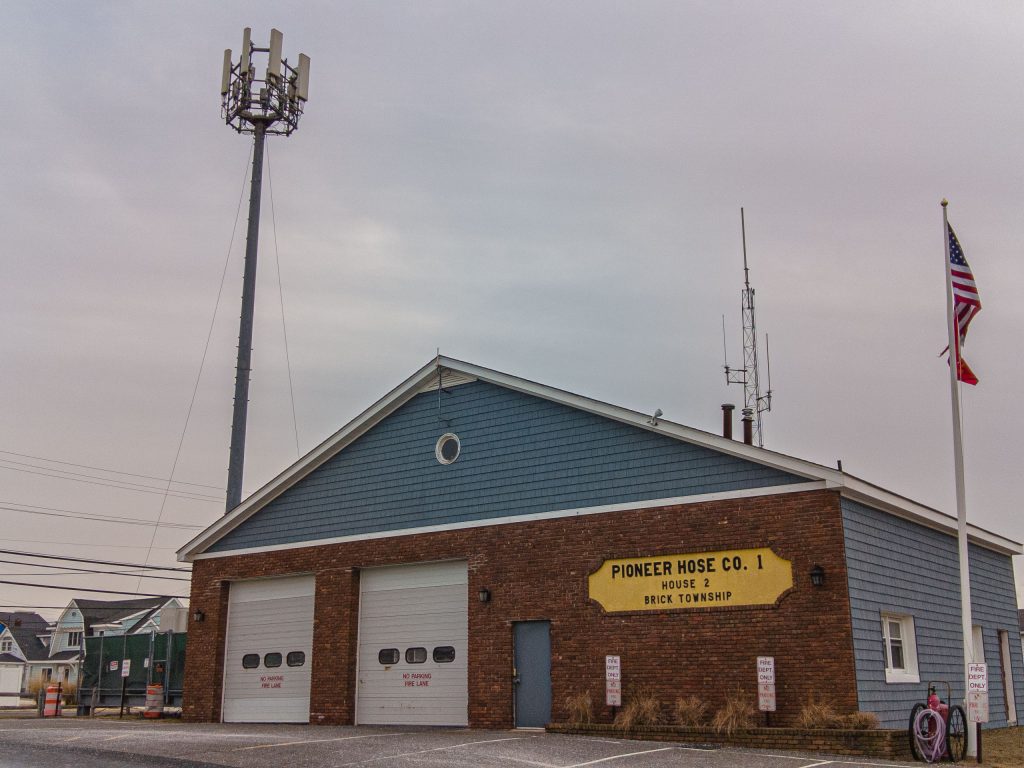 The Pioneer Hose fire company's station on Route 35 in Brick, flanked by a communications tower. (Photo: Daniel Nee)