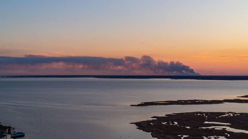 A controlled burn takes place March 6, 2023 in Lacey Township, as photographed from Normandy Beach. (Photo: Daniel Nee)