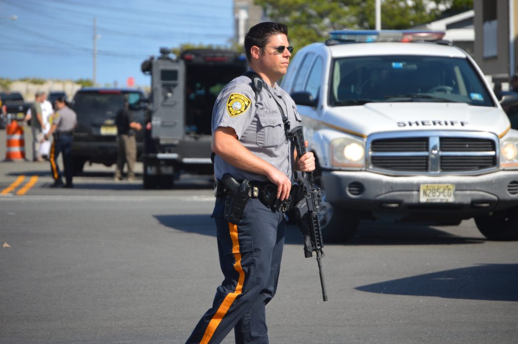A heavily-armed Seaside Park police officer patrols the area near D Street, where a bomb exploded Saturday morning. (Photo: Daniel Nee)